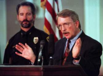 District Attorney Alex Hunter, right, answers questions, Feb. 13, 1997, about the murder of 6-year-old JonBenet Ramsey during a news conference with Boulder Police chief Tom Koby in Boulder, Colo. Nearly a year after the Dec. 26, 1996, crime, no suspects have been named.(AP Photo/Joe Mahoney, FILE)